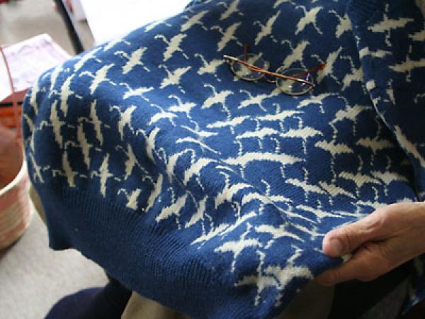 ご主人がデザインして編んだ鶴の図柄のセーター。身頃の端から端まで模様が変わっている。綴じは澄子さんの担当