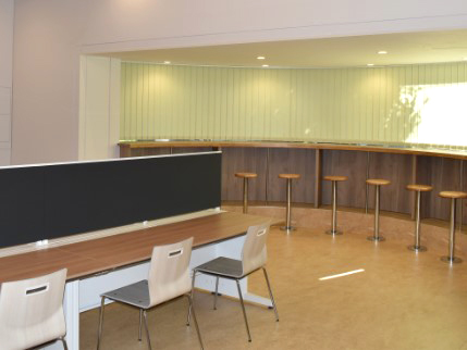 中央に仕切りのあるデスク席と半円形のカウンター席が並ぶ学習スペース（写真提供：東急コミュニティー）